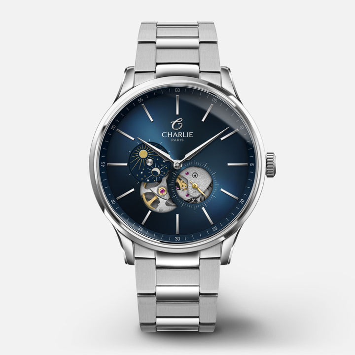 Montre Charlie Paris INITIAL Open Heart Jour/Nuit Bleu 40 mm en acier inoxydable Charlie Paris Montre 3-link stainless steel / Acier inoxydable IDN-40-001 / B-ICO / m-ICO Montre Charlie Paris INITIAL Open Heart Jour/Nuit - Bleu 40 mm | Dépositaire Officiel Canada | Mathieu Blanchard Joaillerie Mathieu Blanchard Joaillerie